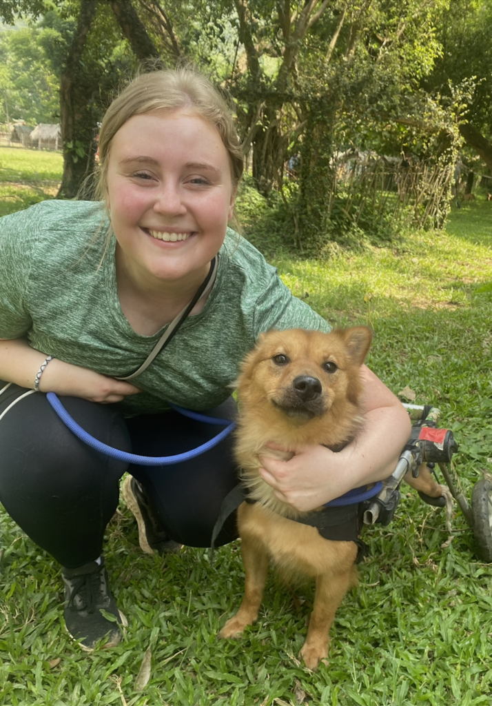 Picture of Emilee with Joey, a dog she worked with in Thailand who was rescued from the illegal dog meat trade.